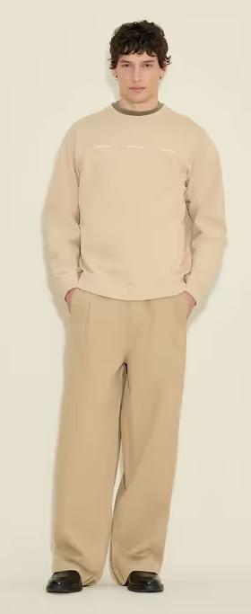 A man wearing Holzweiler duke national crew sand