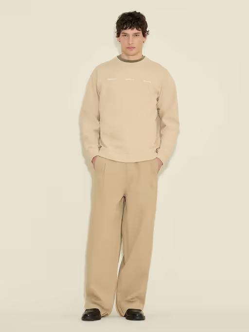 A man wearing Holzweiler duke national crew sand