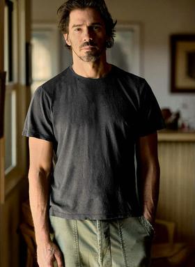 A man wearing imogene and willie cotton hemp crew in faded black t-shirt