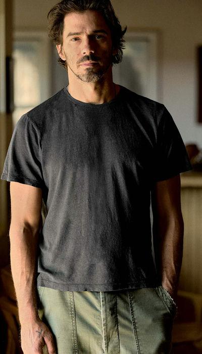A man wearing imogene and willie cotton hemp crew in faded black t-shirt