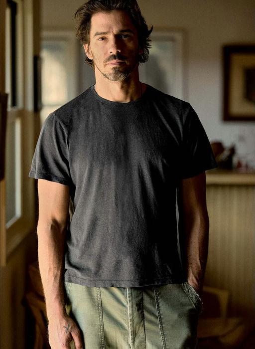 A man wearing imogene and willie cotton hemp crew in faded black t-shirt