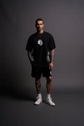 A man wearing Darc Sport perfect form "Premium" oversized tee in black
