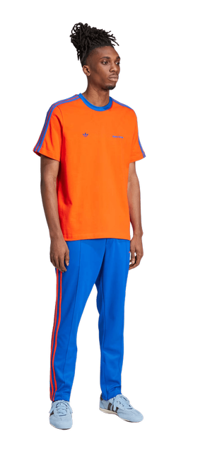 A man wearing YME Universe orange wb s/s tee