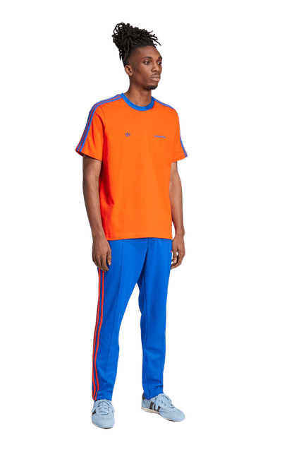 A man wearing YME Universe orange wb s/s tee