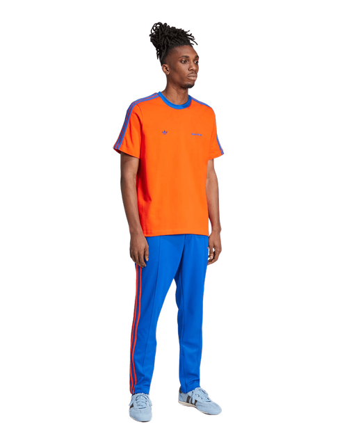 A man wearing YME Universe orange wb s/s tee