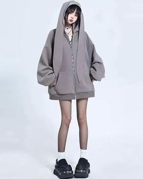 A woman wearing Modakawa long bunny ears pocket oversize zipper hooded grey sweatshirt
