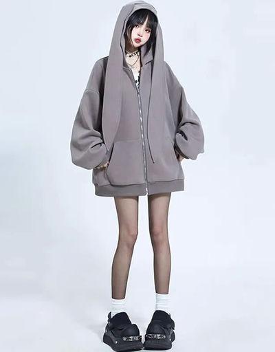 A woman wearing Modakawa long bunny ears pocket oversize zipper hooded grey sweatshirt