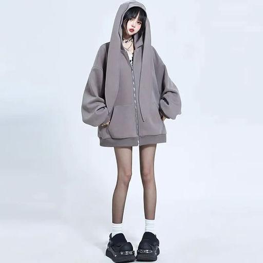 A woman wearing Modakawa long bunny ears pocket oversize zipper hooded grey sweatshirt
