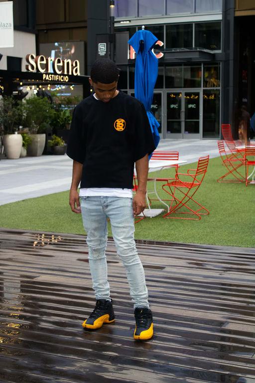 A man wearing Bands Clothing black t-shirt