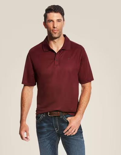 A man wearing Ariat maroon polo