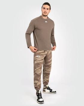 A man wearing Venum ufc adrenaline by venum fight week men’s long sleeve t-shirt - bronze