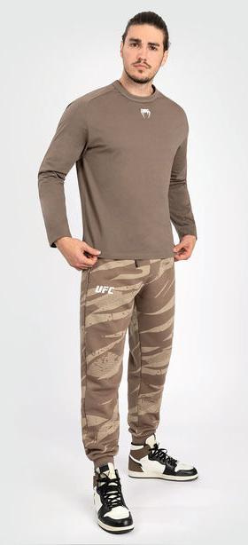 A man wearing Venum ufc adrenaline by venum fight week men’s long sleeve t-shirt - bronze