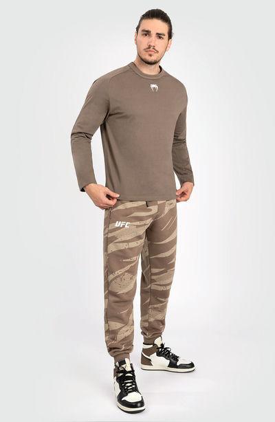 A man wearing Venum ufc adrenaline by venum fight week men’s long sleeve t-shirt - bronze