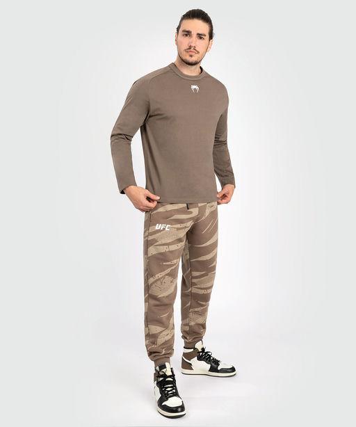 A man wearing Venum ufc adrenaline by venum fight week men’s long sleeve t-shirt - bronze