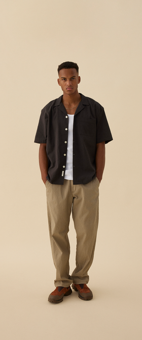 A man wearing Forét hush ss shirt - washed black