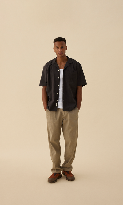 A man wearing Forét hush ss shirt - washed black