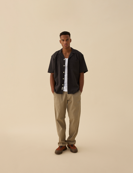 A man wearing Forét hush ss shirt - washed black