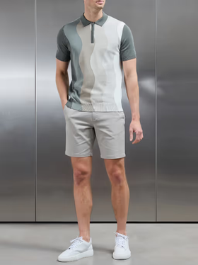 A man wearing arne wave knitted zip polo shirt - sage