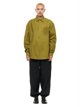 A man wearing olive green Merely Made natural dyed lazy over shirt