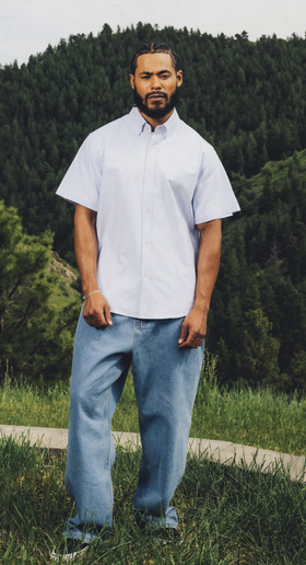 A man wearing a Jiberish Boston striped blue button up shirt