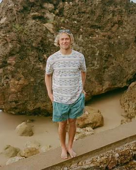 A man wearing Howler Bros lombok : bone white terry t-shirt