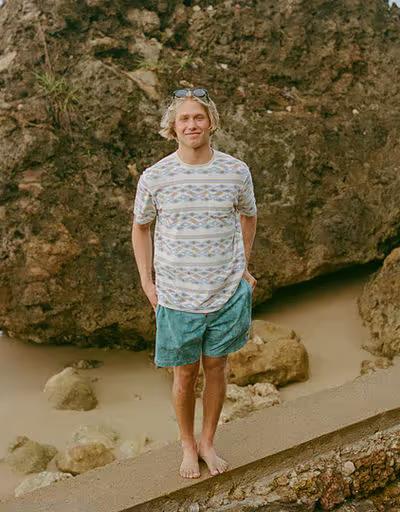 A man wearing Howler Bros lombok : bone white terry t-shirt