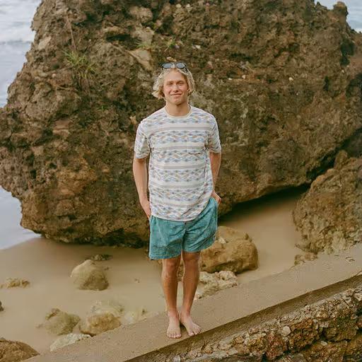 A man wearing Howler Bros lombok : bone white terry t-shirt