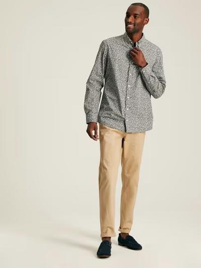 A man wearing Joules green floral cotton shirt