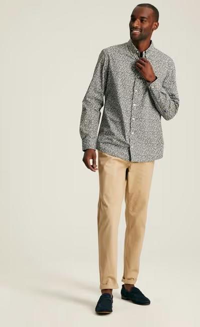 A man wearing Joules green floral cotton shirt