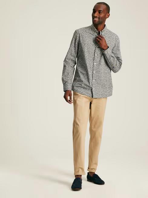 A man wearing Joules green floral cotton shirt