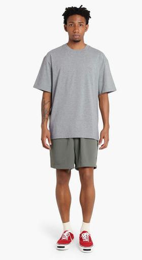 A man wearing Madness grey madness logo tee