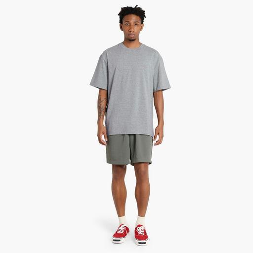 A man wearing Madness grey madness logo tee