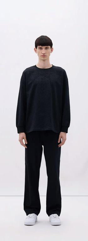 A man wearing Les Benjamins black long sleeve tee