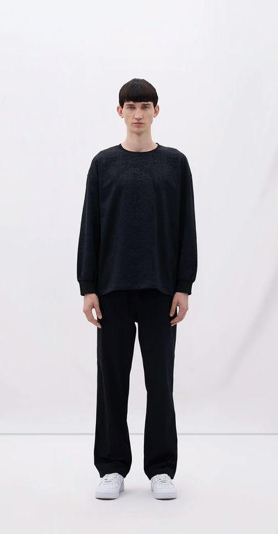 A man wearing Les Benjamins black long sleeve tee