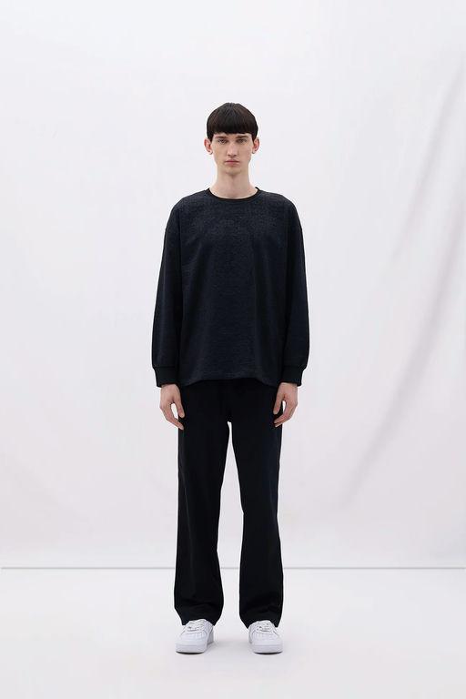A man wearing Les Benjamins black long sleeve tee