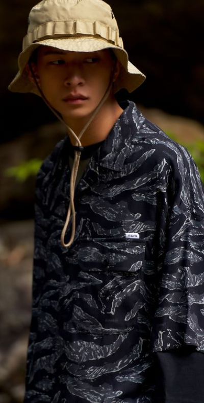 A man wearing Double-park army hawaii shirt featuring a camouflage color palette