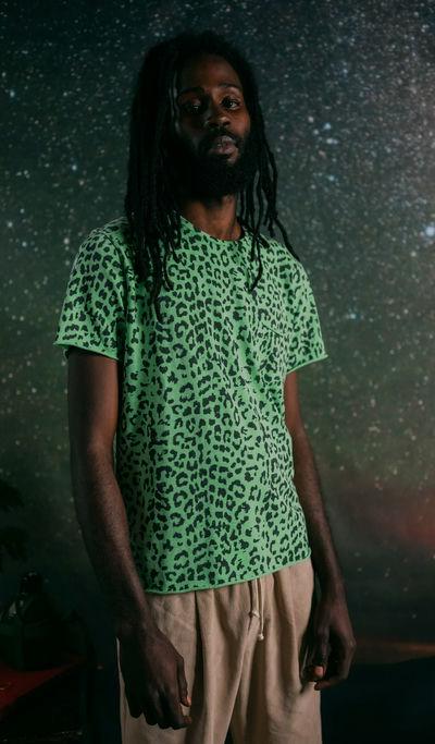A man wearing +351 t-shirt leopard neon green