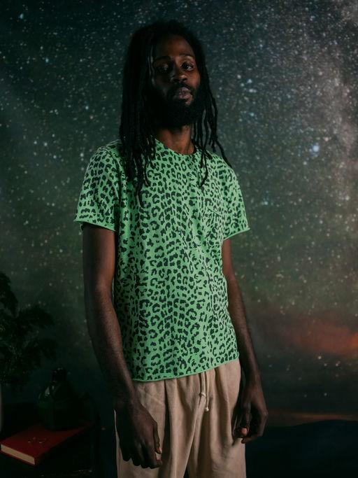 A man wearing +351 t-shirt leopard neon green