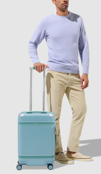 A man with PARAVEL aviator100 carry-on plus luggage