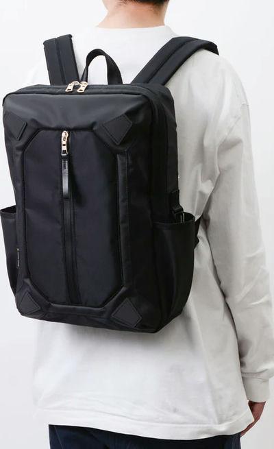 A man carrying MASTER-PIECE osaka metro × master-piece collaboration series backpack