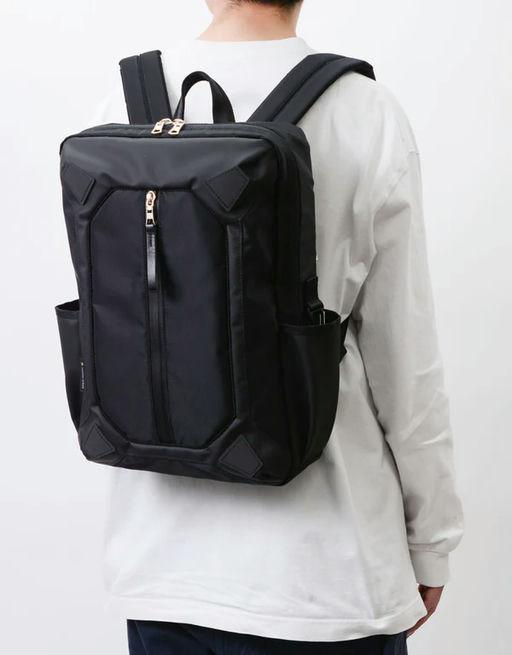 A man carrying MASTER-PIECE osaka metro × master-piece collaboration series backpack