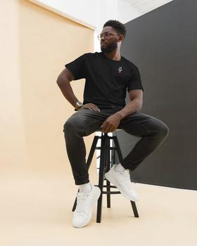 A man wearing Double B radiasi black t-shirt