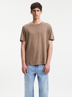A man wearing A Day's March clay color nyx lyocell t-shirt