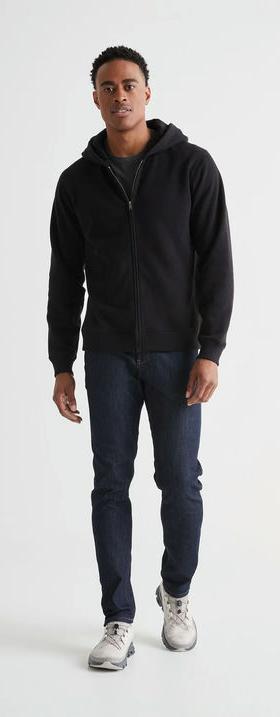 A man wearing DUER brushed terry performance zip up - black