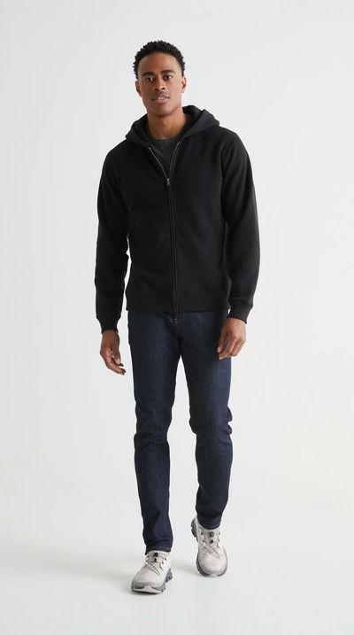 A man wearing DUER brushed terry performance zip up - black