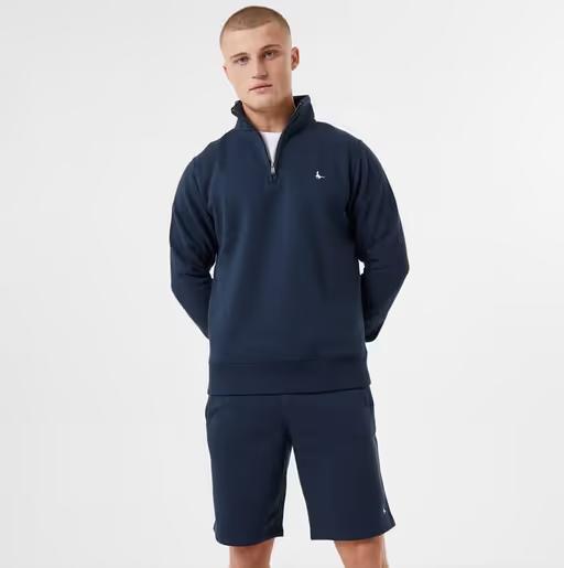 A man wearing Jack Wills navy color barchester quarter zip sweatshirt