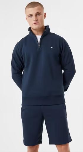 A man wearing Jack Wills navy color barchester quarter zip sweatshirt