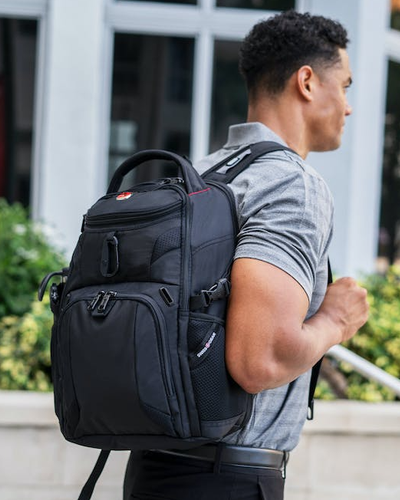 A man wearing a Swiss Gear backpack in black