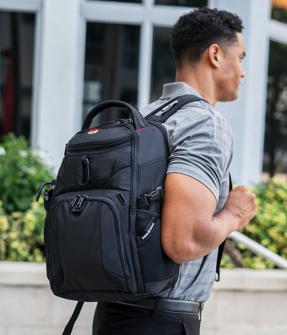 A man wearing a Swiss Gear backpack in black