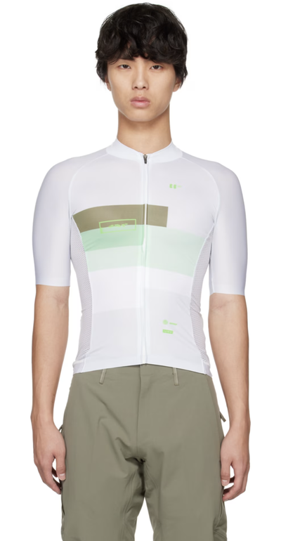 A man wearing a BBUC cycling outfit in white and green